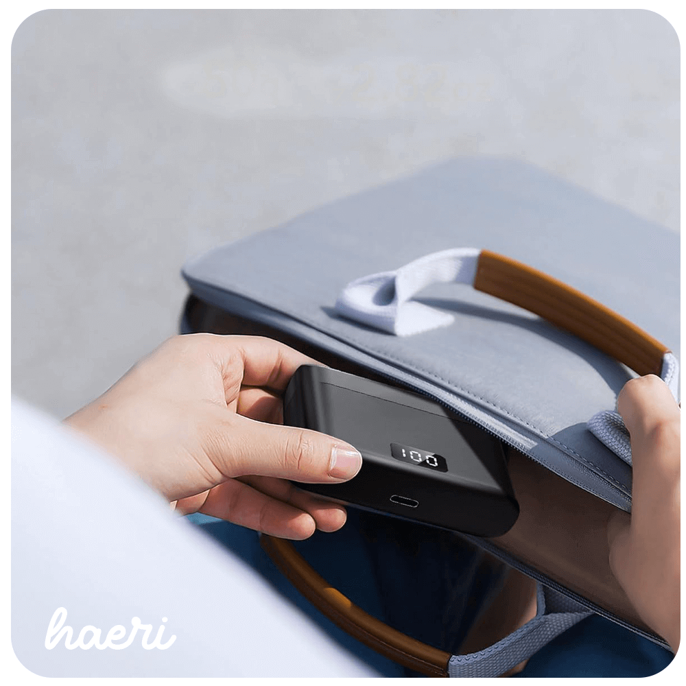 Wireless charger being placed in a bag, showcasing portability and convenience.