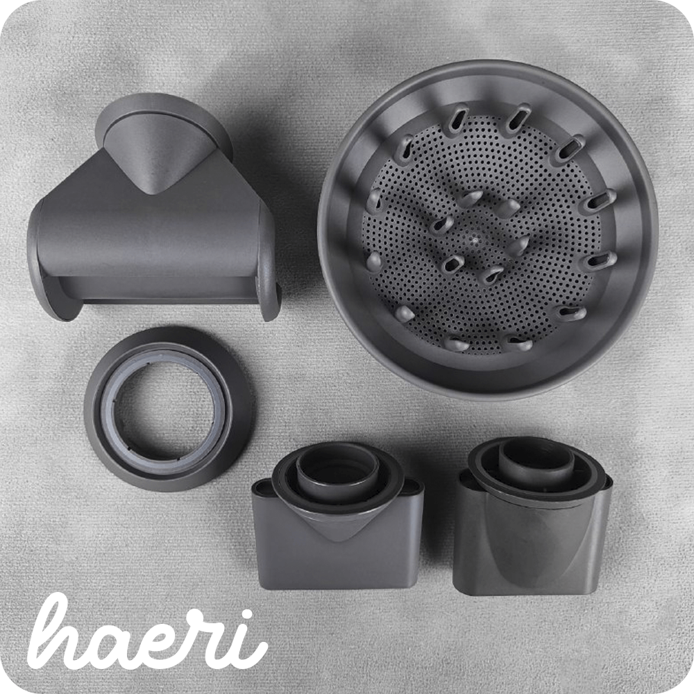 Various hair dryer attachments on a gray background, including a diffuser and concentrator nozzle.