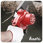 Close-up of a hand using a red cordless chainsaw to cut a branch, showcasing precision and power.