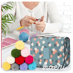 Person crocheting with colorful yarn and a stylish storage bag, perfect for DIY projects and gifts.