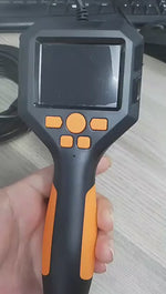 Handheld endoscope camera controller with a small display and control buttons.