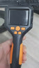 Handheld endoscope camera controller with a small display and control buttons.